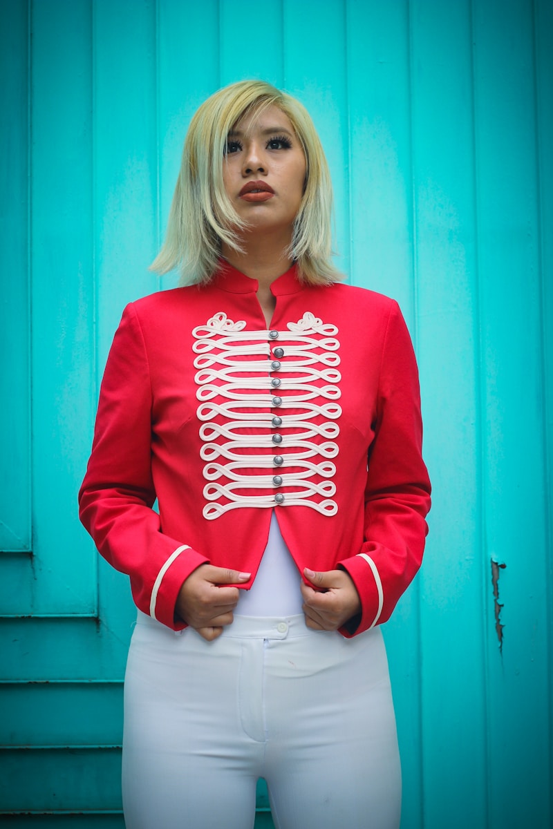 a woman in white pants and a red jacket