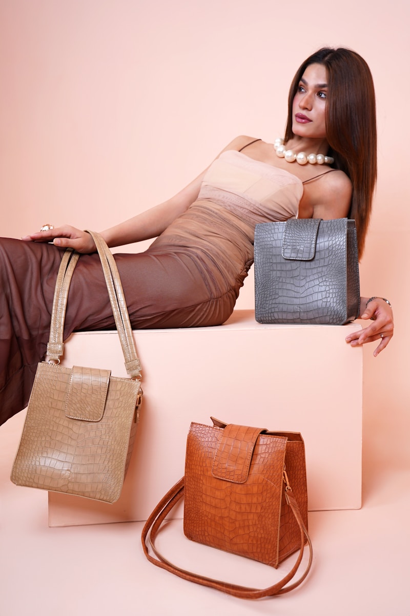 a woman sitting on a box holding two purses