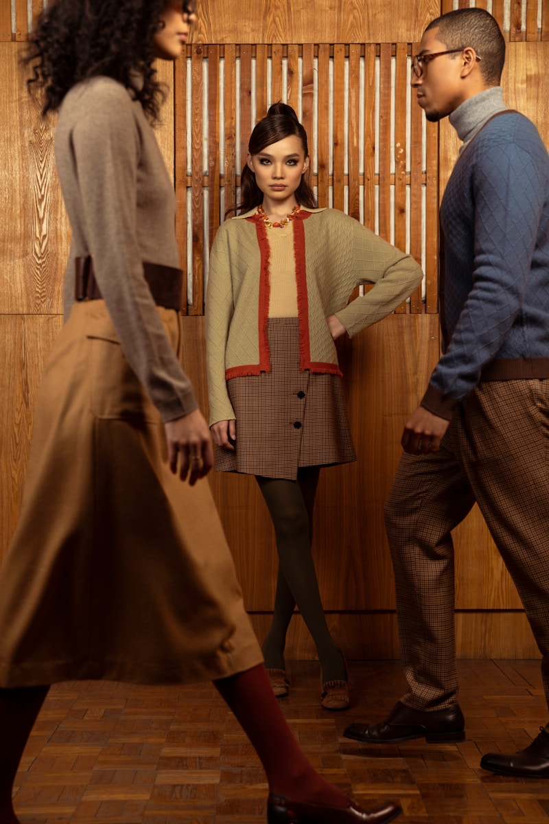 man in blue dress shirt and brown pants standing beside woman in brown coat