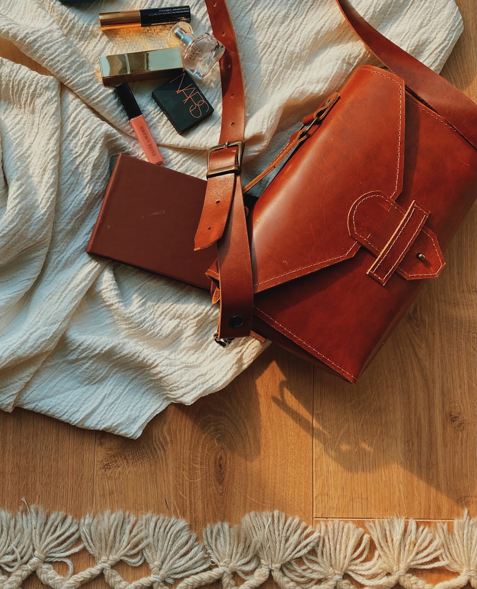 a brown purse sitting on top of a wooden floor