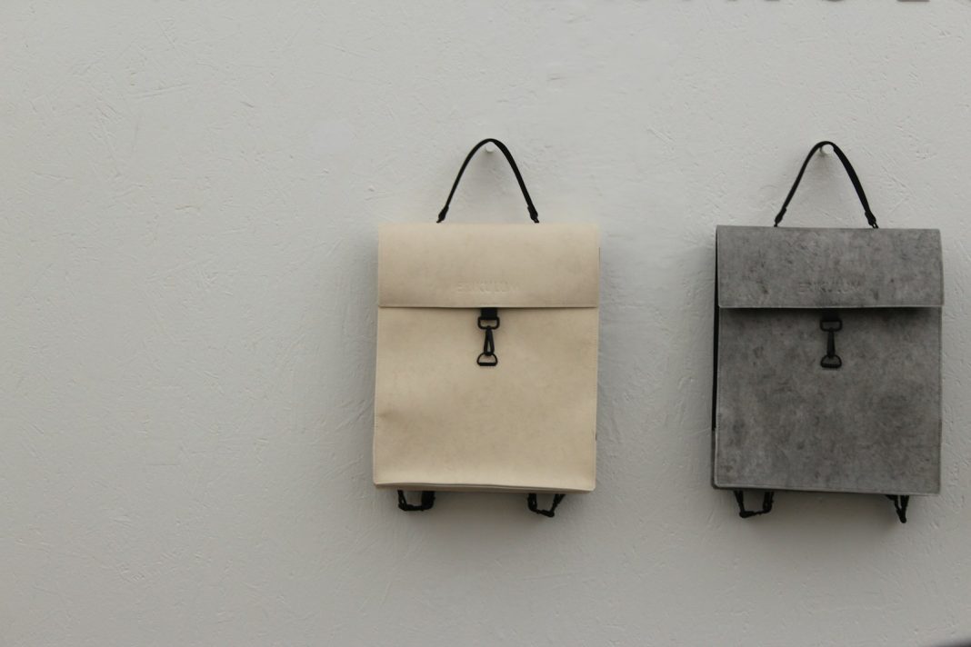 brown paper bag on white wall
